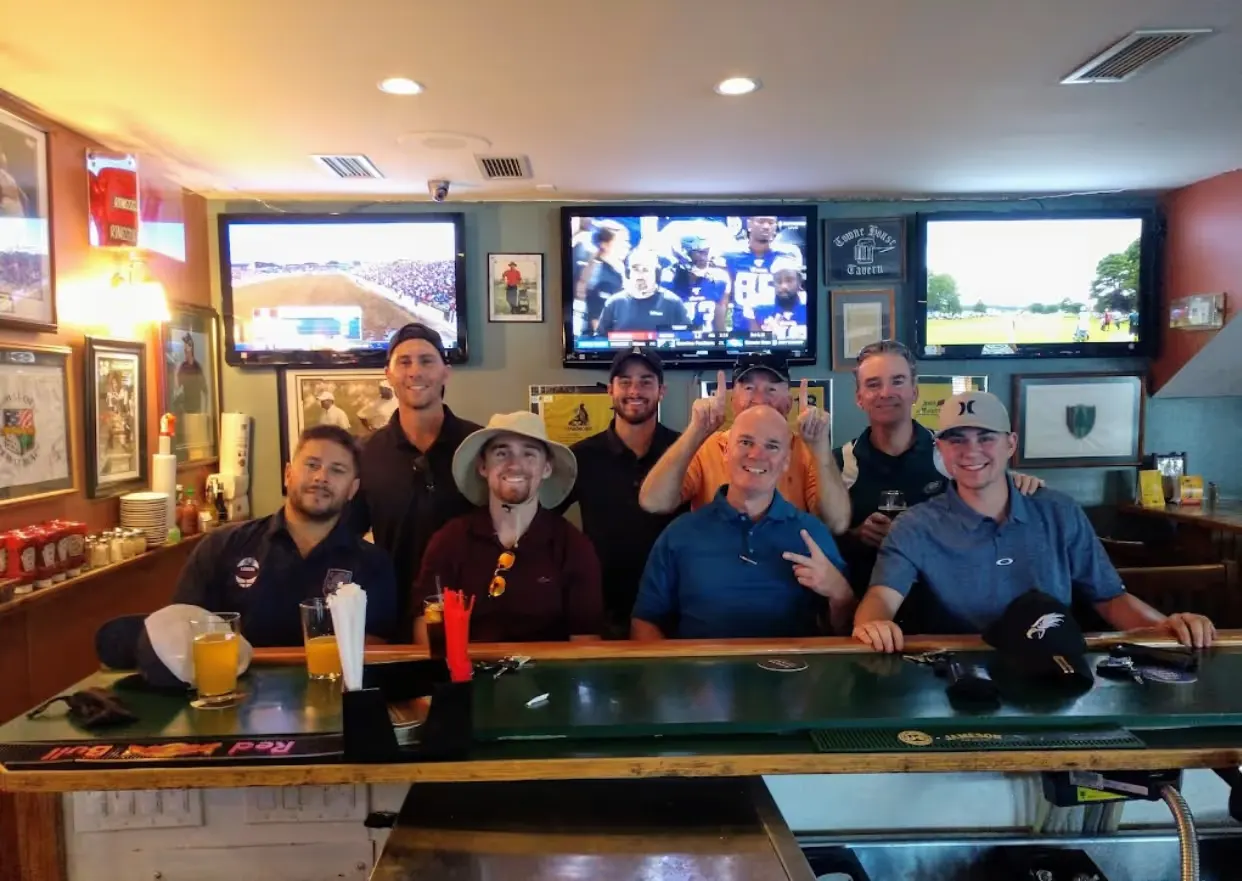 Friends gathered at Juliano's bar with sports on the televisions
